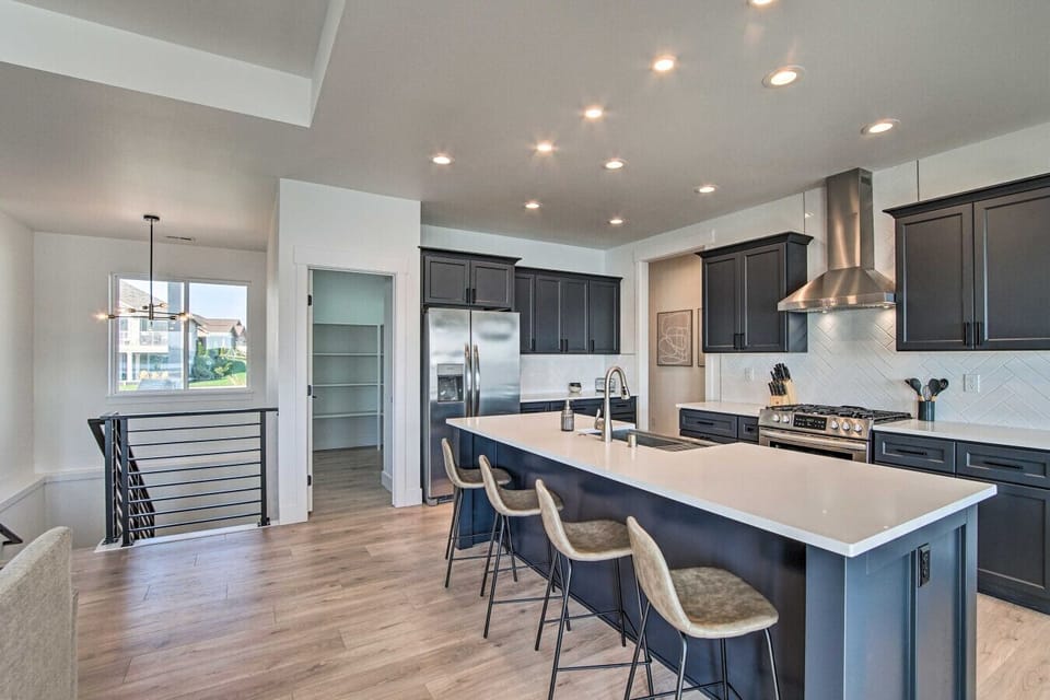 Kitchen | Large Island Seating | Stainless Range | Dark Cabinet Contrast