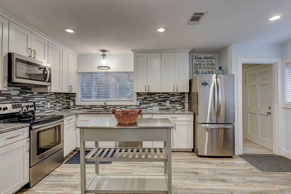 Fully stocked kitchen with all stainless steel appliances.