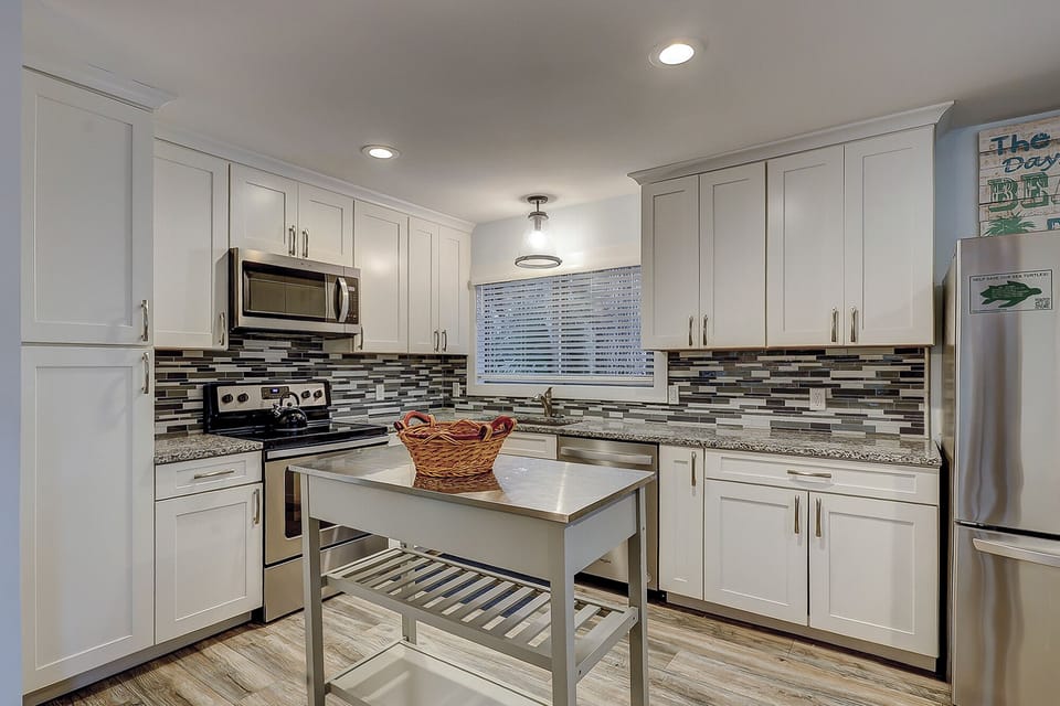 Fully stocked kitchen with all stainless steel appliances.