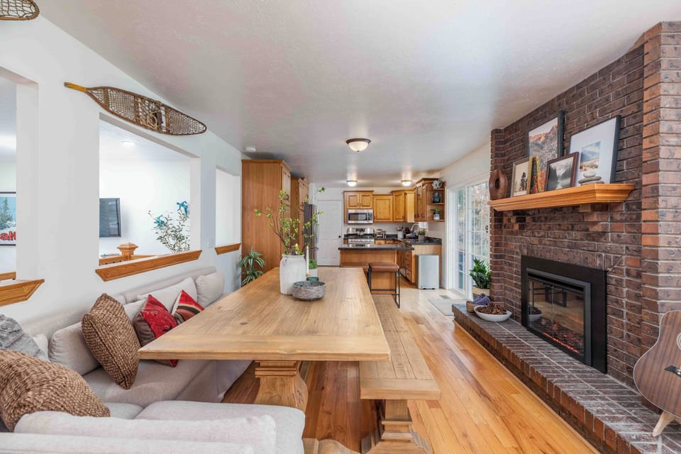Dining table with kitchen view and cozy fireplace.