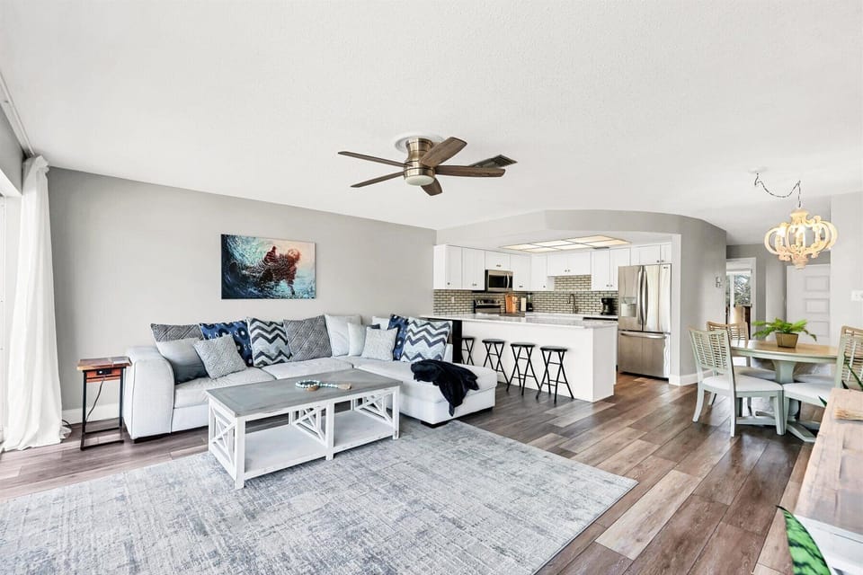 Relax in your bright, open-concept space where modern comfort meets coastal style. Plush sectional seating flows into a fully equipped kitchen.