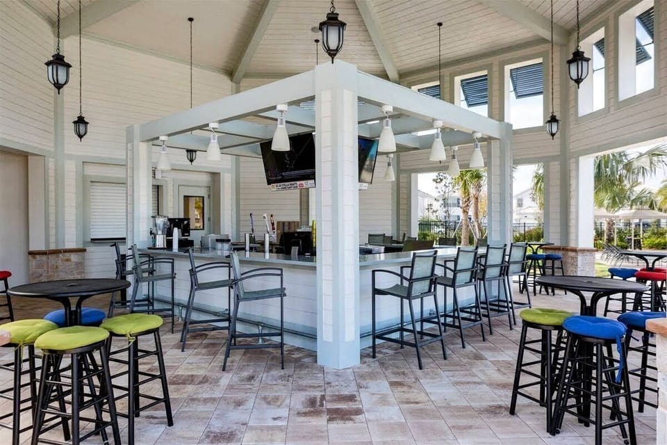 Grab a refreshing drink and catch the game at the vibrant open-air poolside bar.