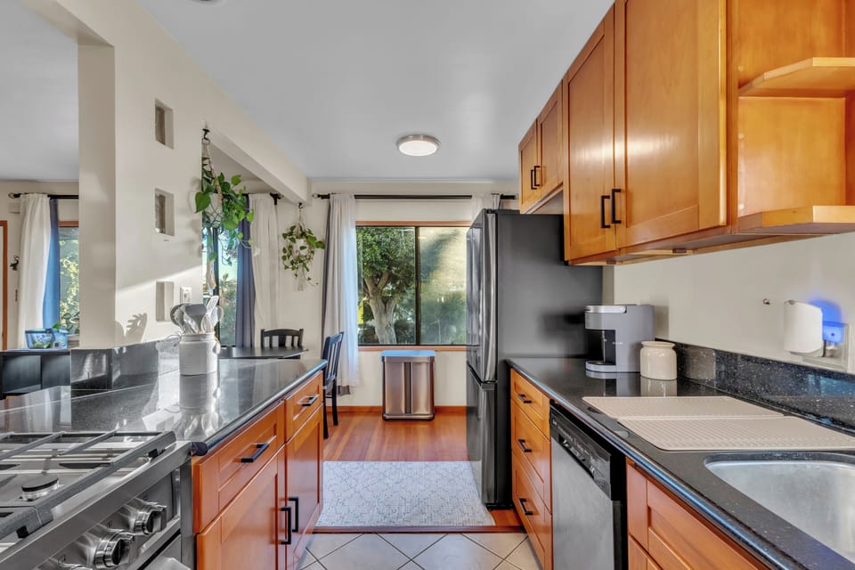 Fully equipped modern kitchen with stainless steel appliances.
