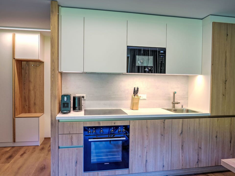 Interior Design, Countertop, Kitchen, Wood, Flooring, Cabinetry, Furniture, Floor, Kitchen Appliance, Major Appliance