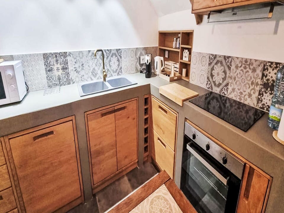 Flooring, Countertop, Floor, Interior Design, Kitchen, Cabinetry, Room, Kitchen Appliance, Wood Stain, Home Appliance
