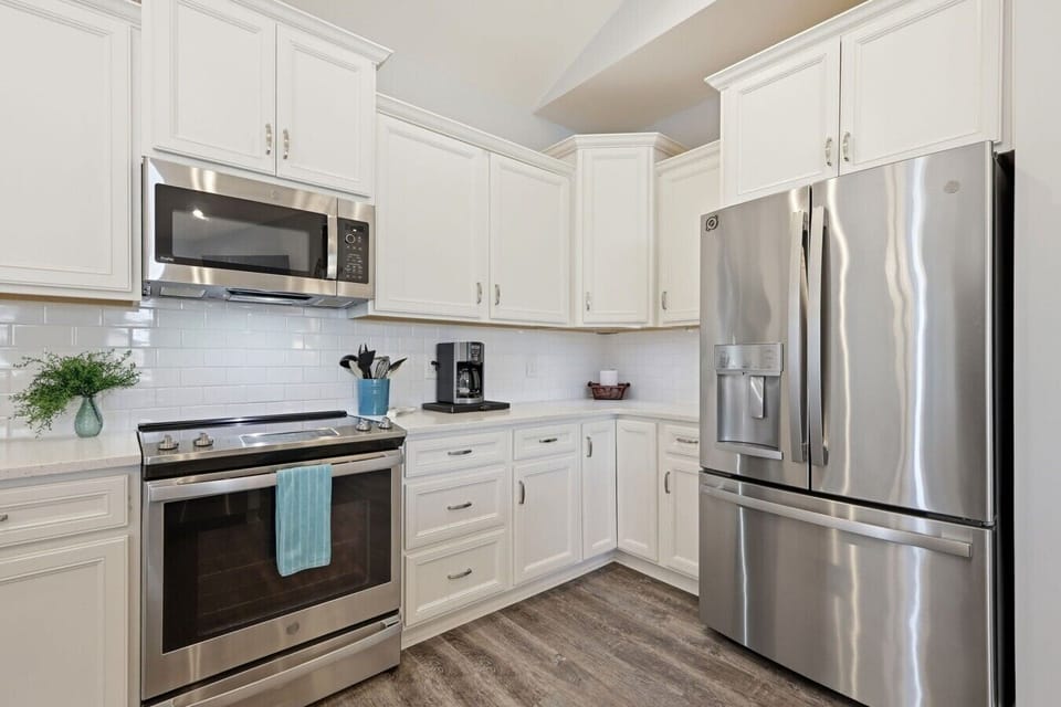 Prepare your favorite meals in this fully equipped kitchen featuring stainless steel appliances and ample counter space