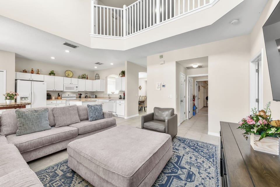 FAMILY:  Rear Living Room Area with 75” 4K UHD Resolution Smart TV, Adjacent to Master Suite, Powder Room & Laundry Room