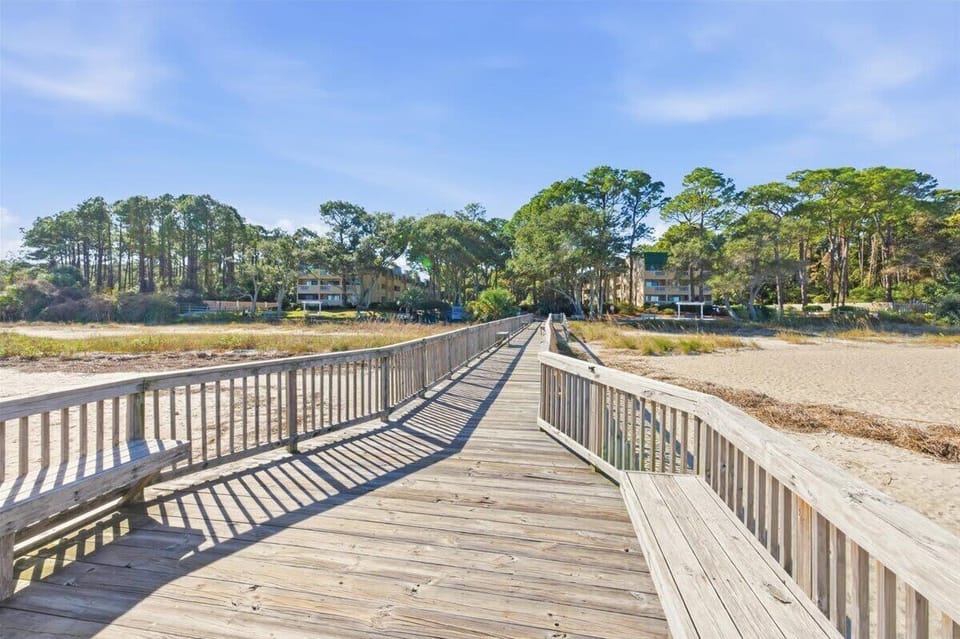 Steps from the shore with a private boardwalk, scenic pier, and relaxing beachside swings.