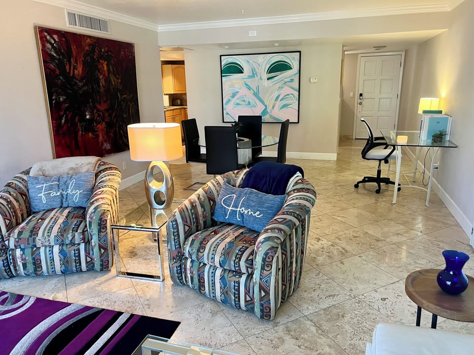 Livingroom with working & dining tables and original large paintings