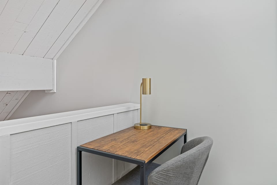 Ideal for remote work is the office area offering a desk, chair and desk lamp 