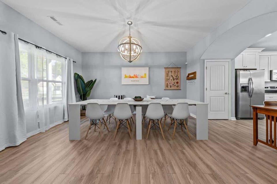 Dining space w/ table, soft lighting & open connection to kitchen