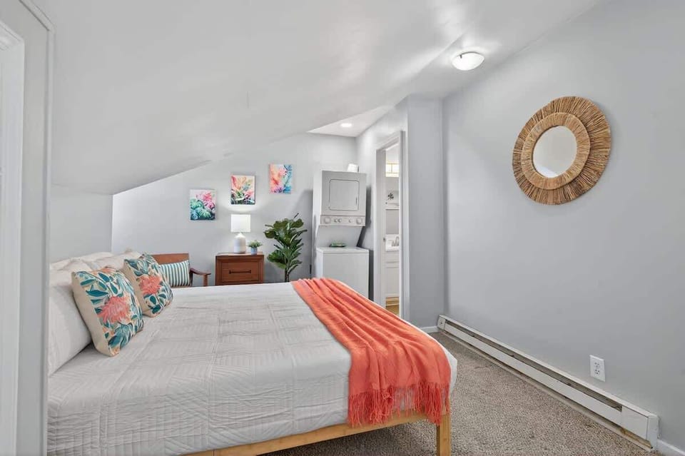 This final bedroom angle showcases a spacious layout with a comfortable bed and modern decor. Neutral tones create a calm, relaxing space perfect for unwinding. 