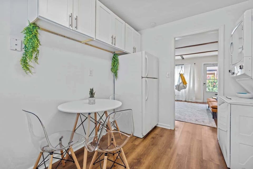 Relax in a bright living room w/ cozy sofa seating, TV & sunlight streaming through large windows