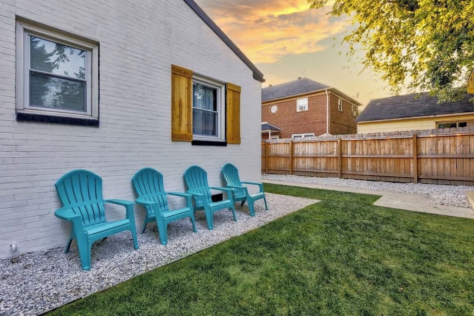 Side yard w/ outdoor chairs, offering a quiet spot to sit & unwind