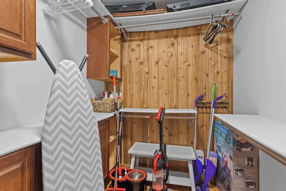Organized storage area w/ shelving & hooks for keeping items neatly arranged