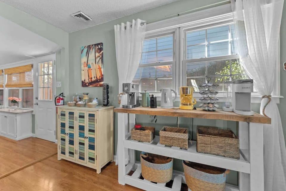 Sunlit breakfast nook w/ bar seating & windows for relaxed morning coffee