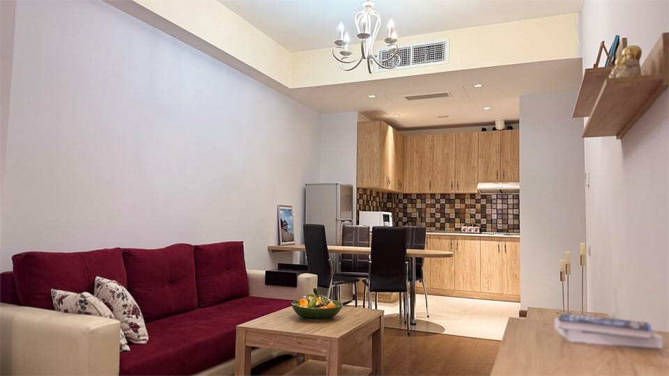 Deluxe Apartment, 1 Bedroom, Balcony, Courtyard View | Living area | 50-inch Smart TV with cable channels