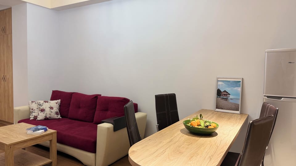Deluxe Apartment, 1 Bedroom, Balcony, Courtyard View | Living area | 50-inch Smart TV with cable channels