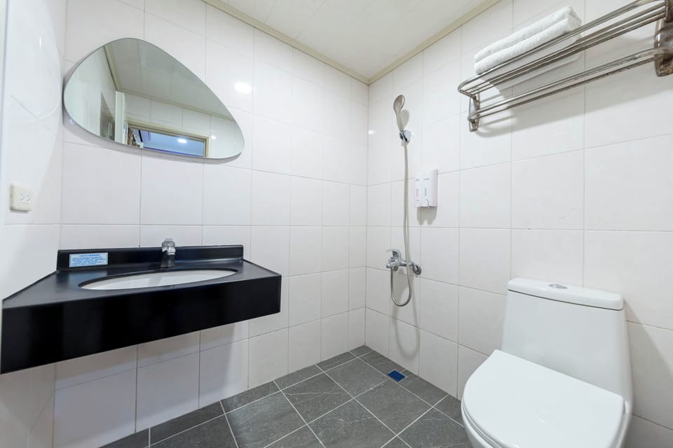 Shower, hair dryer, slippers, towels