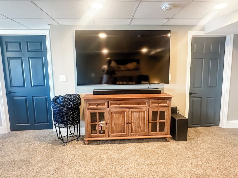 The lower level living space is the perfect place for a cozy movie night and steps from the lake.
