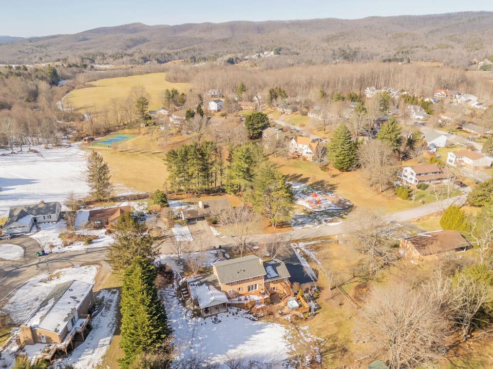 Well-maintained, inviting brick home set in a quiet, tree-lined neighborhood with expansive green space, community amenities, and scenic surroundings.