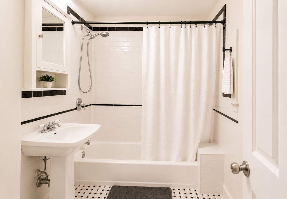 Clean, well-maintained bathroom with a shower and bathtub combination, stocked with essentials and designed to make getting ready easy and comfortable.