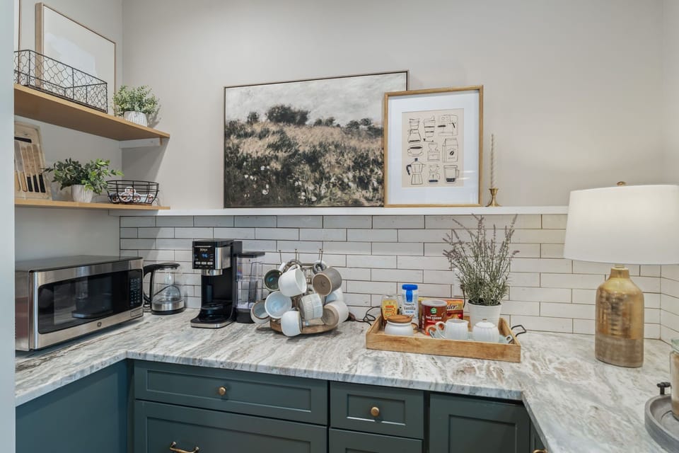 Your mornings start perfectly with premium coffee facilities and marble countertops in this thoughtfully designed kitchen corner.