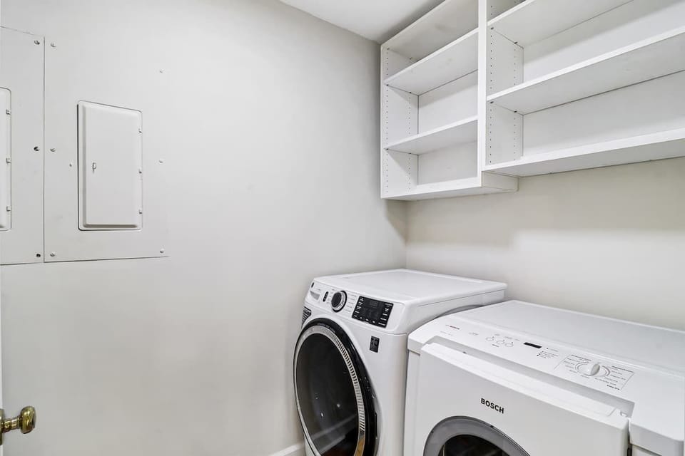 Your private laundry room keeps clothes fresh throughout your stay, with built-in shelving for storage convenience.