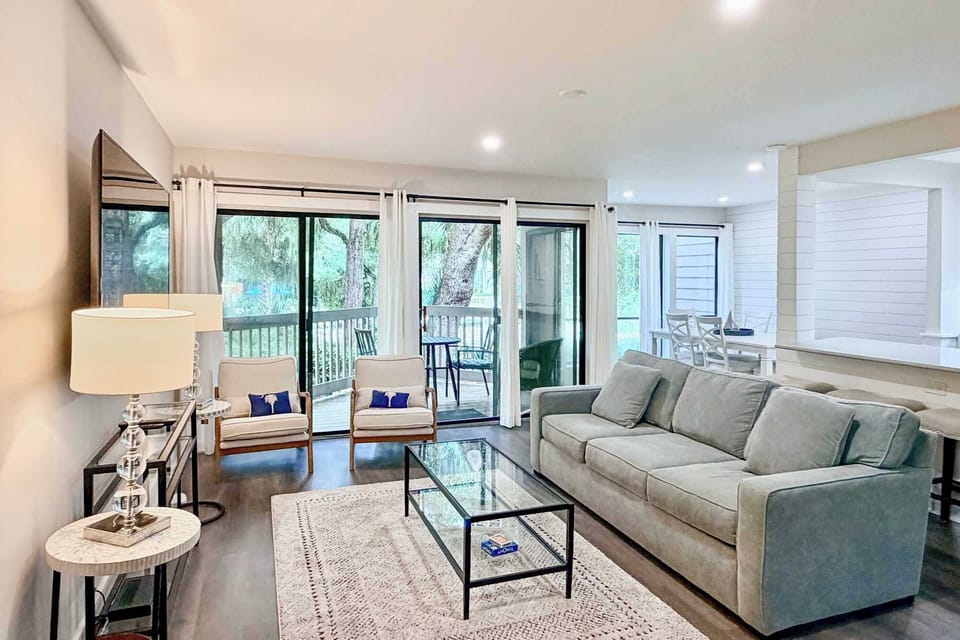 Unwind in your spacious living room with plush seating, natural light streaming through large windows, and a private balcony perfect for morning coffee.