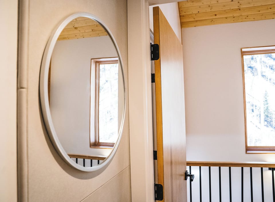 Hall mirror reflects the airy space