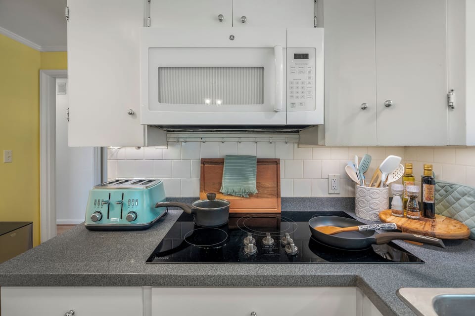 Clean and well-lit kitchen featuring a double sink and charming garden window