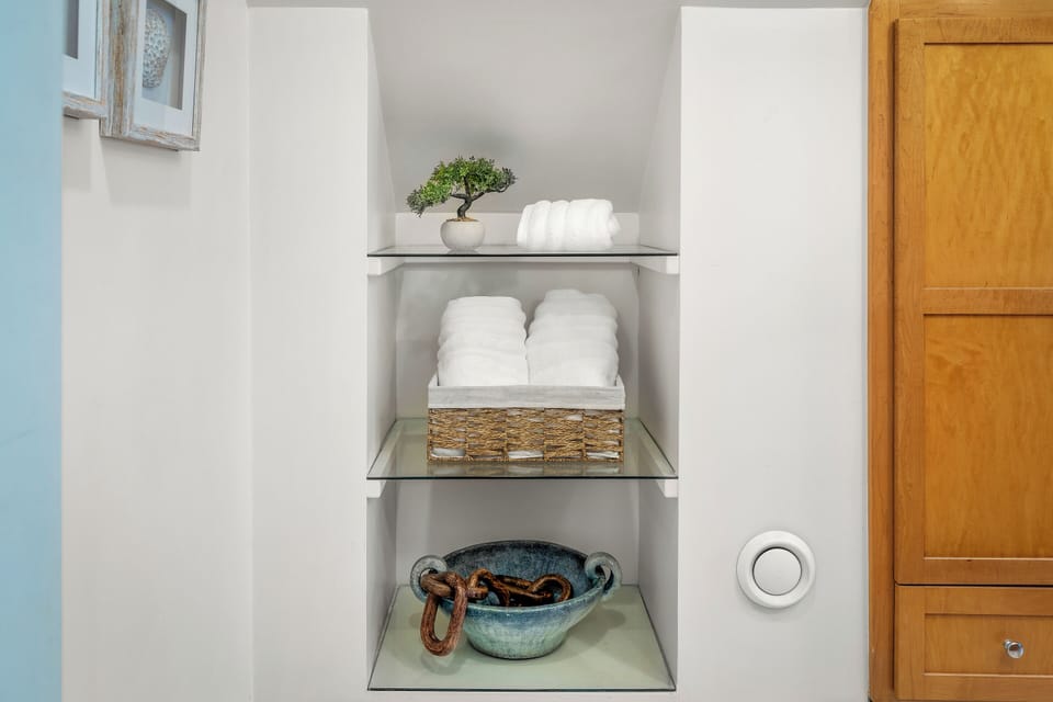 Fresh towels and extra essentials are neatly stored and ready for your use.