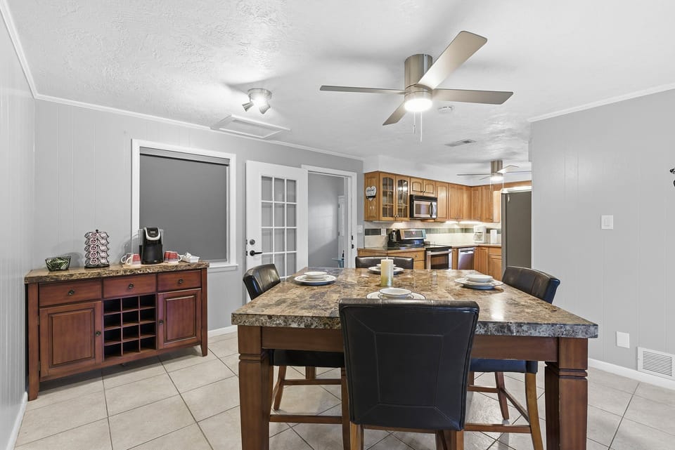 Enjoy this beach stay dining area with a stylish table, cozy seating, and a convenient coffee bar—perfect for morning brews or evening meals after a relaxing day at the beach.
