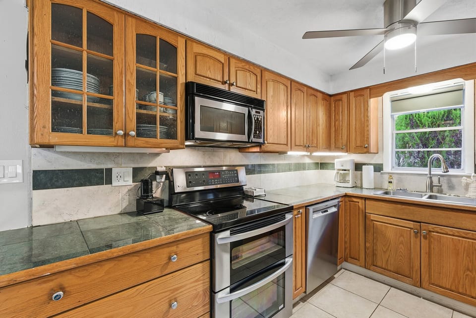 Cook with ease in this beach stay kitchen featuring modern appliances, generous counter space, and plenty of storage—ideal for preparing meals after a fun-filled day at the beach.