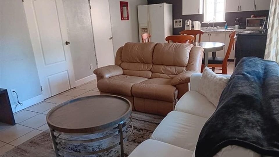 Living room with sofa seating and kitchen access