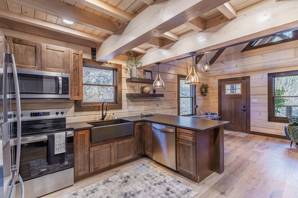 Full kitchen  with sainless steal appliances and farmhouse style sink