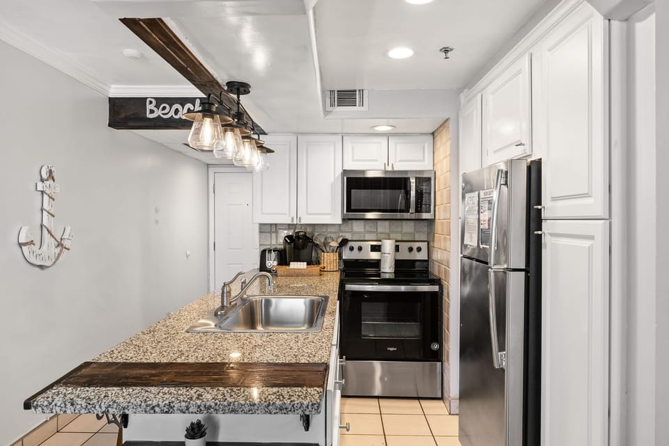 Modern kitchen with stainless steel appliances and granite countertops