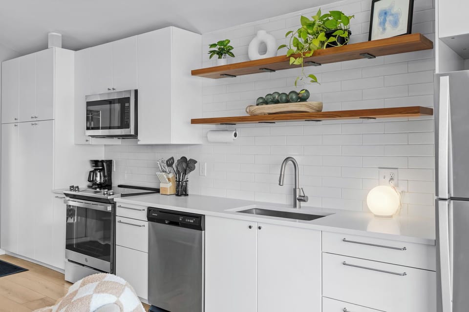 This bright, modern kitchen features everything you need to prepare meals, with sleek appliances and thoughtful details.