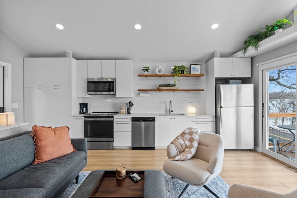 Your bright open-plan living space seamlessly blends kitchen and lounge, with modern appliances and cozy seating perfect for relaxing together.