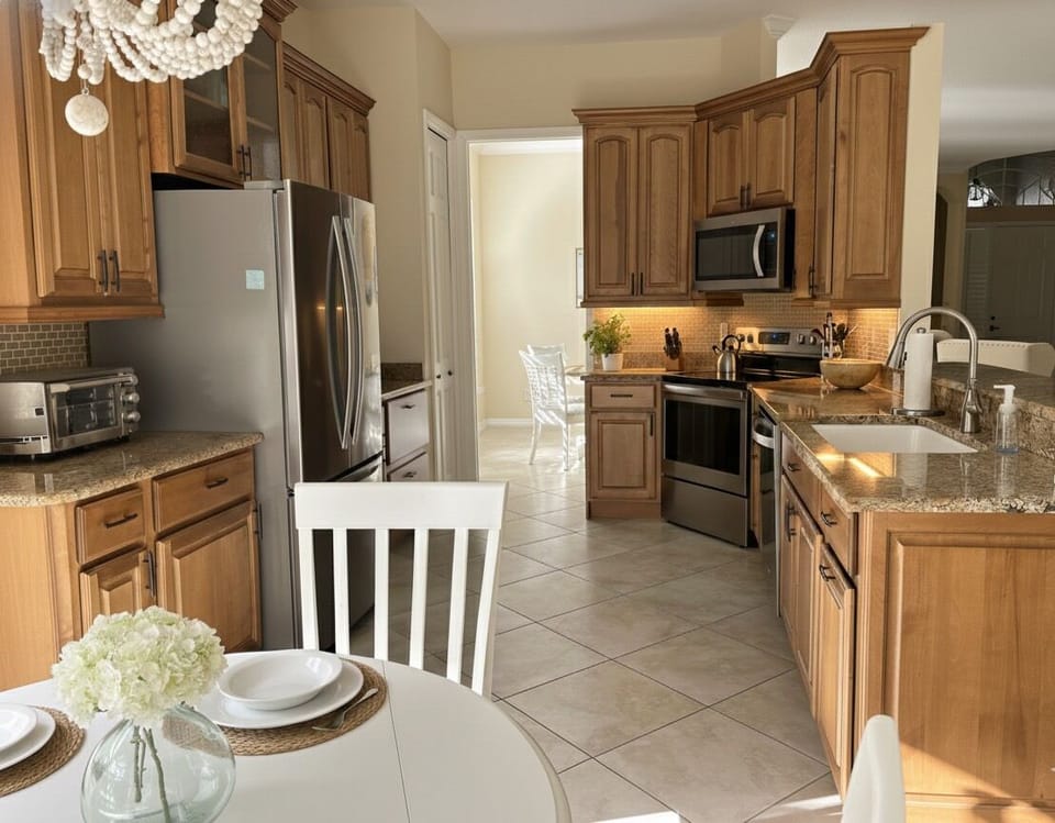 Kitchen is fully equipped with dishware, glassware, utensils and cooking tools