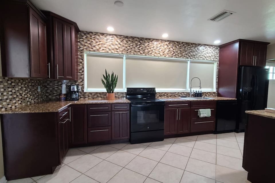 Cook with a view! Our full kitchen features a wall oven, island seating, and is fully stocked with dishes/pots. The open-concept design flows into the living room, allowing you to watch the lagoon and dolphins right from the kitchen island.