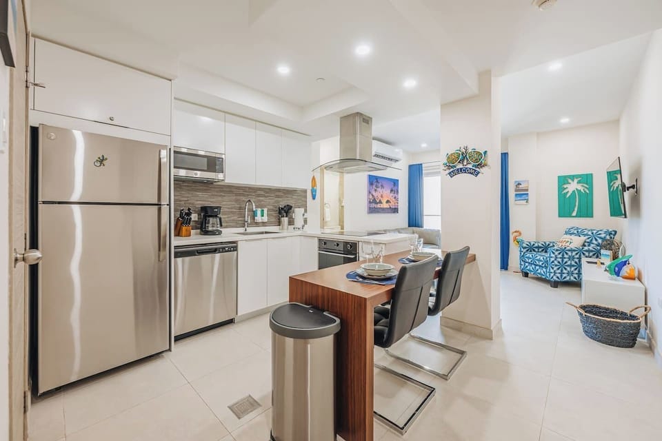 A wide view of the kitchen toghether with the dining and living room