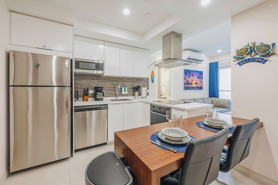 The kitchen is conveniently located next to the living area and dining space. It comes fully equipped with a stove, refrigerator, microwave, coffee maker, sink, and complete utensils for cooking and serving meals with ease.