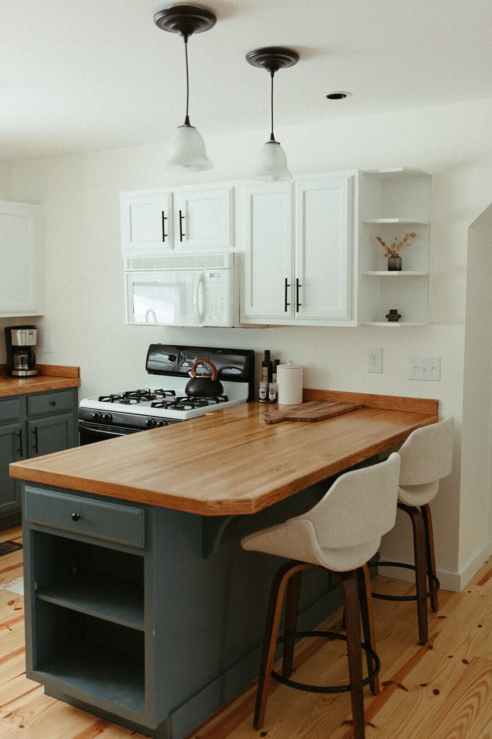 Main floor kitchen with a spacious island, seating, and everything you need for group meals, snacks, and coffee before heading out.