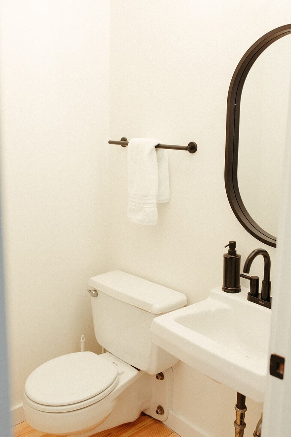 Main floor half bath with clean finishes and modern fixtures, perfect for quick use during gatherings.