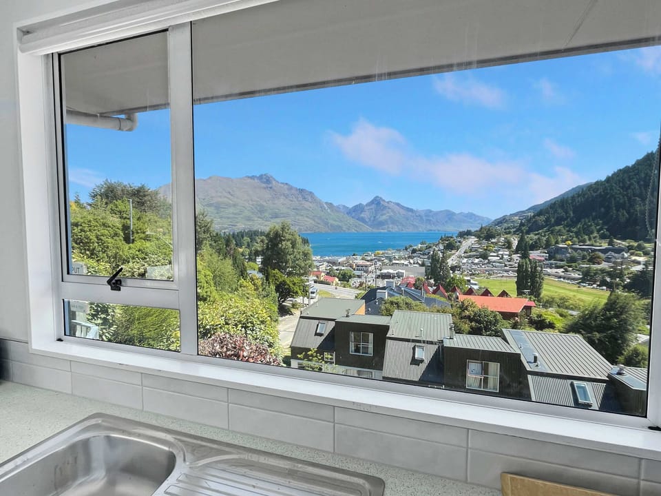 Kitchen window framing lake and mountain outlook