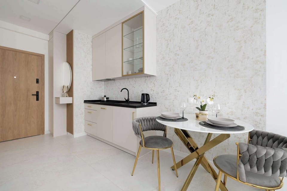The sleek design of the kitchenette blending seamlessly with the living area.
