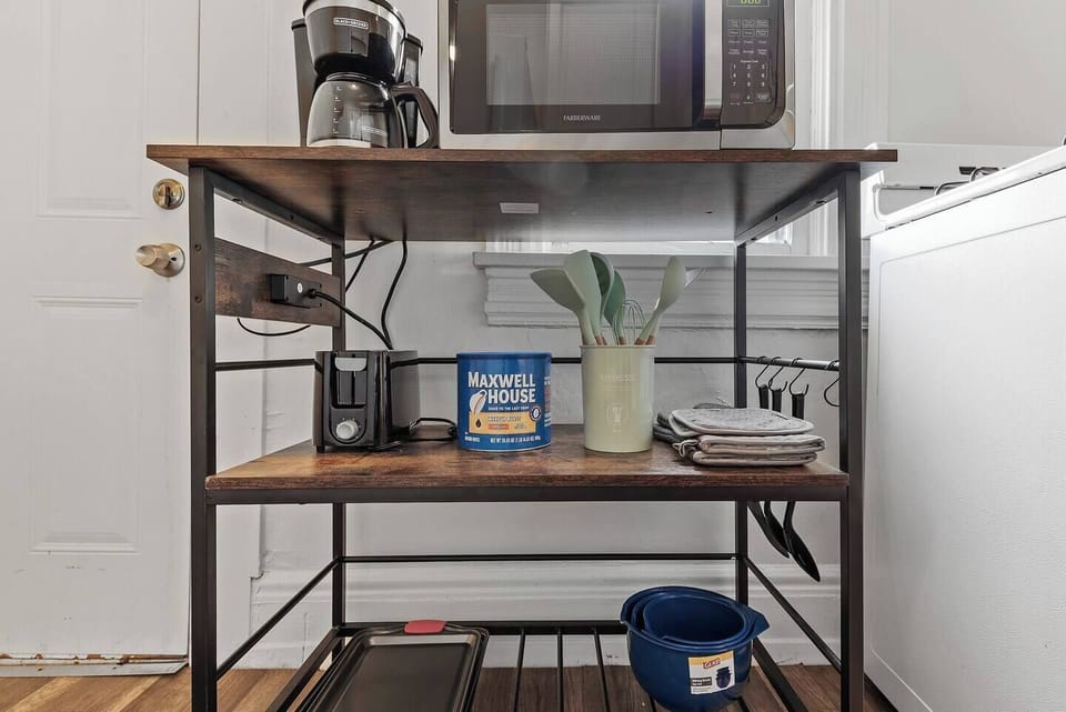 Whip up a quick breakfast with the toaster and coffee maker, letting the aroma fill your bright, cozy kitchen space.