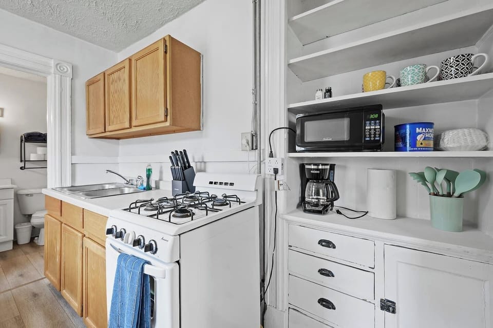 Compact kitchen stocked for simple cooking.