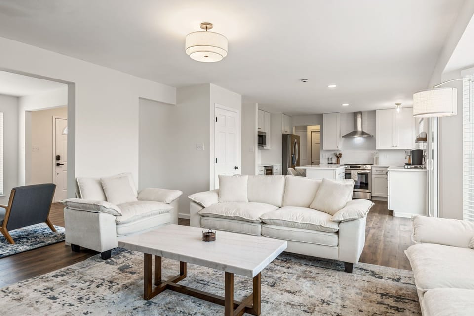 The bright living room offers a spacious sectional seating area with an easy connection to the kitchen.